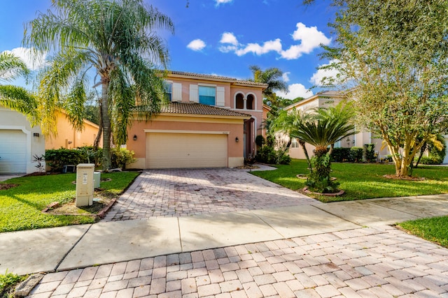 mediterranean / spanish home with a garage and a front lawn