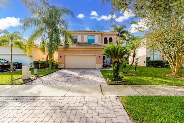 mediterranean / spanish home with a front lawn and a garage