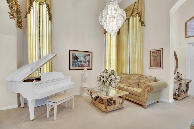 carpeted living room featuring a notable chandelier