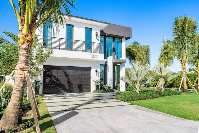 view of front of home with a garage and a front yard