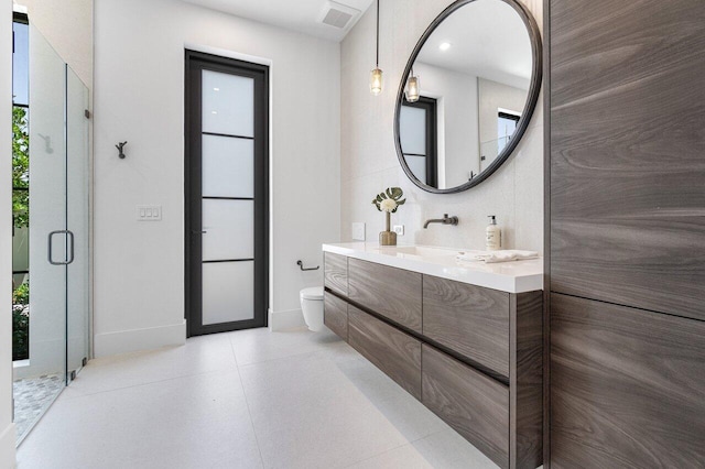 bathroom with vanity, toilet, and walk in shower