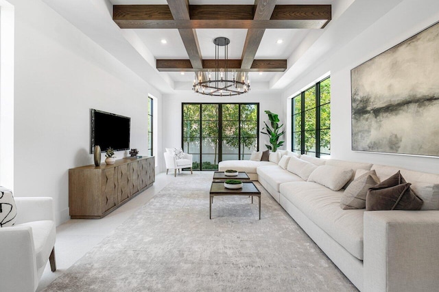 living room with beam ceiling, a notable chandelier, and coffered ceiling