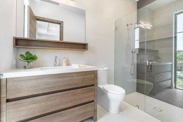 bathroom featuring tile patterned flooring, vanity, an enclosed shower, and toilet