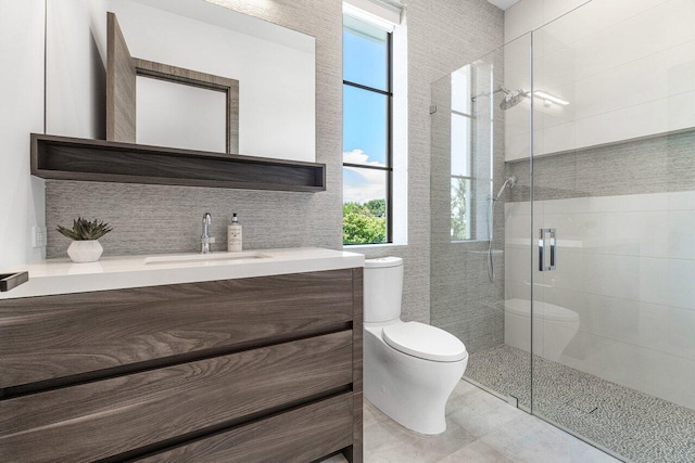 bathroom with vanity, tasteful backsplash, toilet, and an enclosed shower