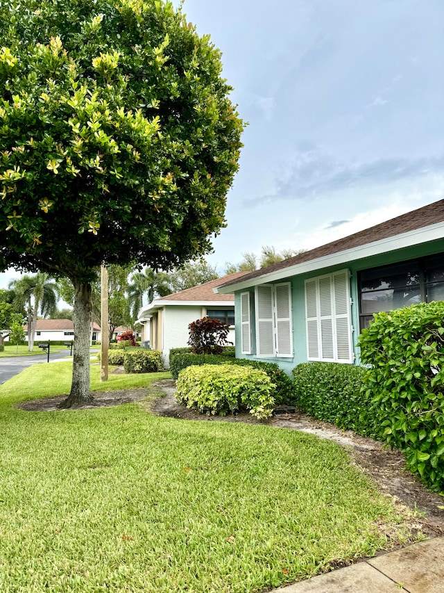 view of side of property featuring a yard