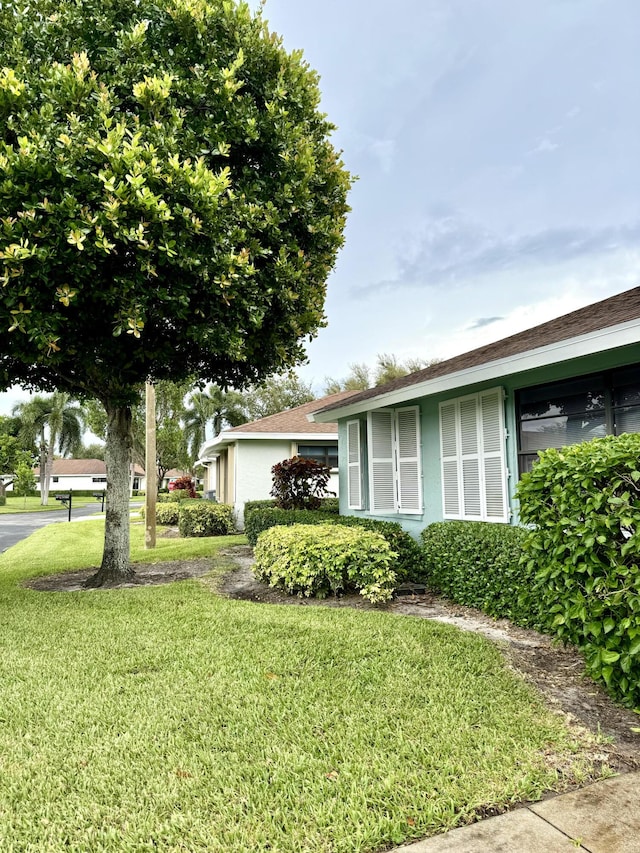 view of side of home featuring a lawn