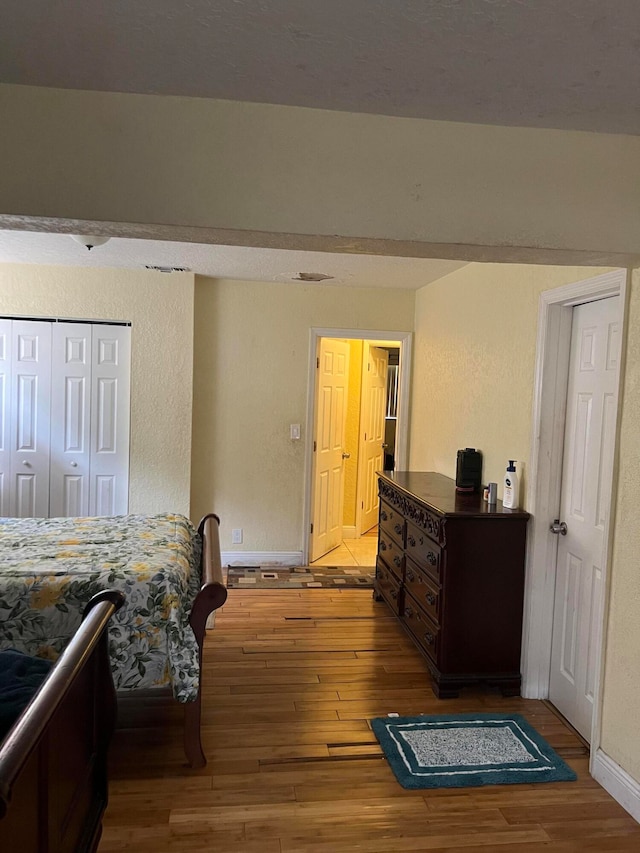 bedroom with a closet and wood-type flooring