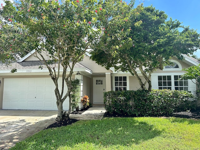 view of front facade featuring a garage and a front lawn