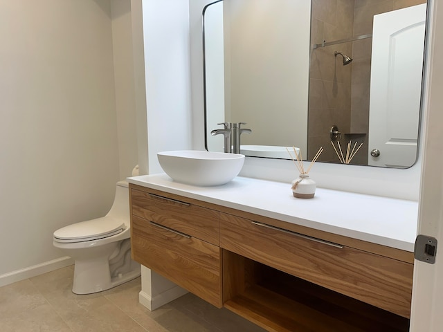 bathroom featuring tiled shower, vanity, toilet, and tile patterned floors