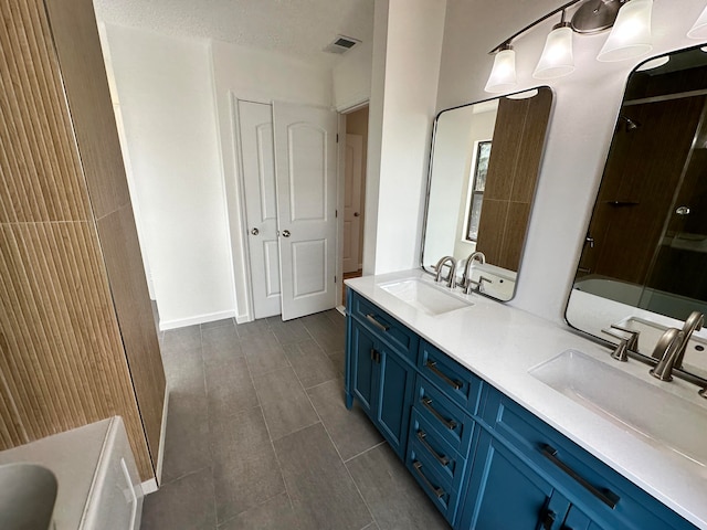 bathroom with a textured ceiling and vanity