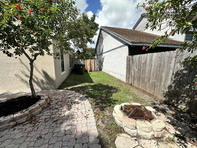 view of yard with a fire pit and a patio area