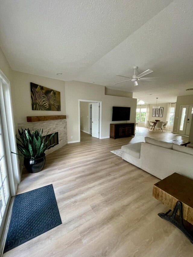 empty room with a textured ceiling, hardwood / wood-style flooring, and ceiling fan