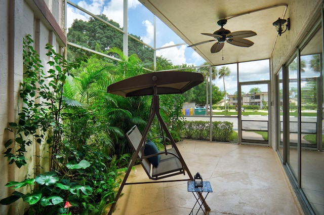 sunroom / solarium featuring ceiling fan