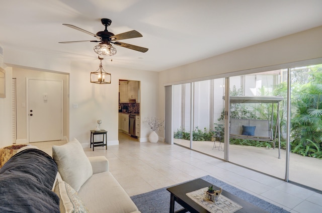 living room with light tile patterned flooring and ceiling fan with notable chandelier