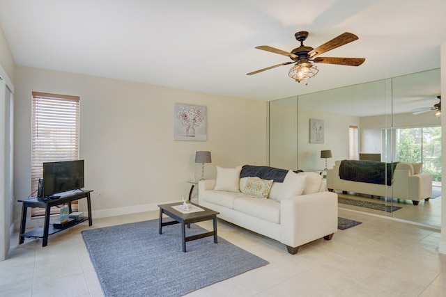 living room with light tile patterned flooring and ceiling fan