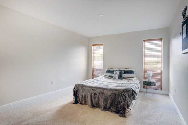 bedroom with light colored carpet