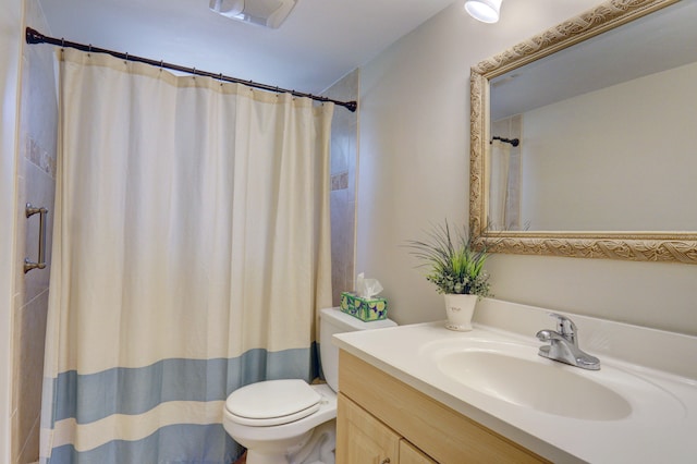 bathroom with vanity, a shower with shower curtain, and toilet