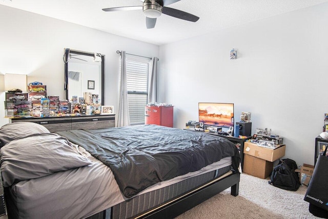 bedroom featuring ceiling fan and light carpet