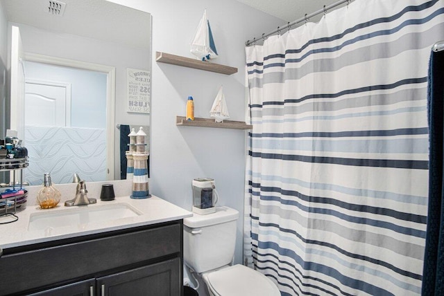 bathroom featuring vanity, toilet, and a shower with shower curtain