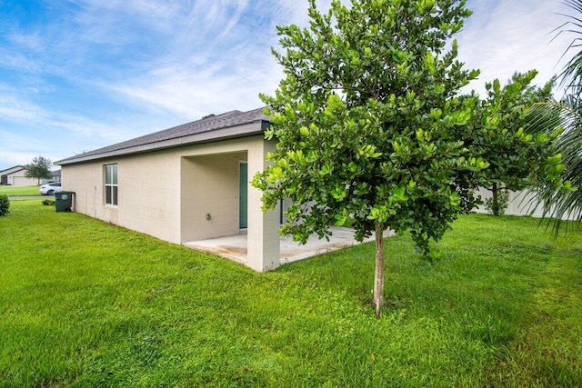 back of property featuring a lawn and a patio area