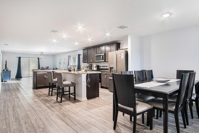 dining area featuring light wood-type flooring