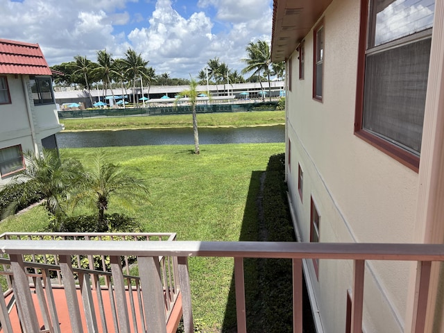 view of yard with a water view and a balcony