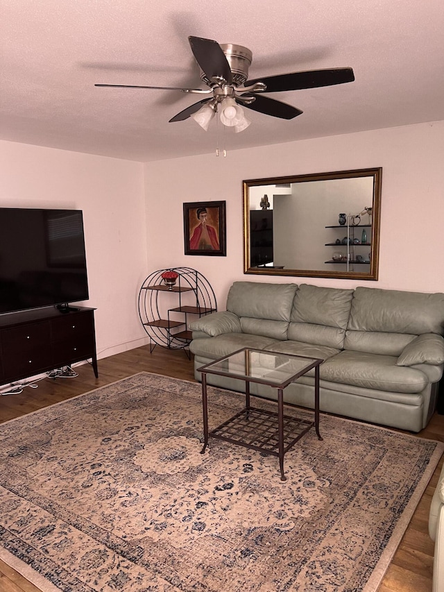 living room featuring a textured ceiling, hardwood / wood-style flooring, and ceiling fan