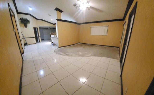 tiled empty room with ceiling fan, ornamental molding, and vaulted ceiling