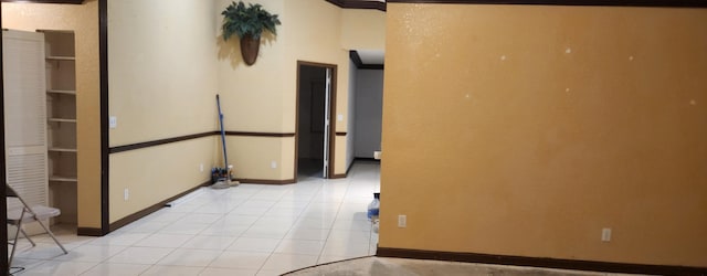 empty room featuring built in features and light tile patterned floors