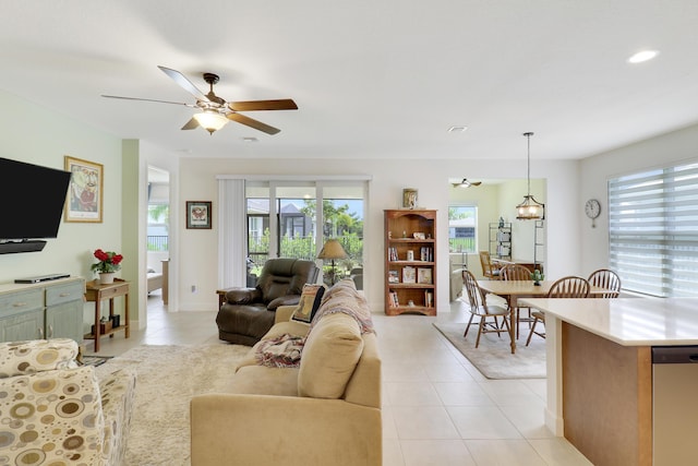 living room with light tile patterned floors and ceiling fan