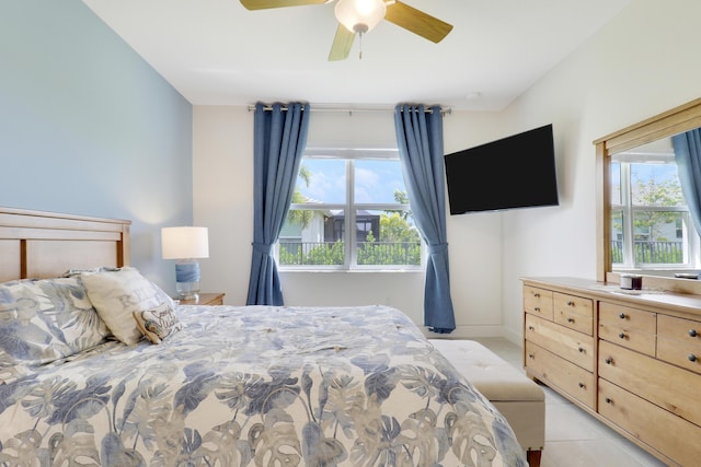 tiled bedroom featuring ceiling fan