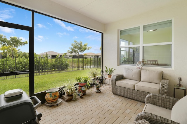 sunroom / solarium with a water view