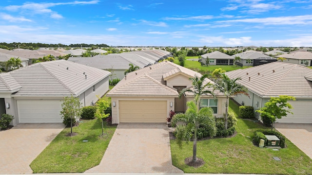 view of front of house with a garage and a front yard