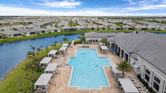 view of swimming pool featuring a patio and a water view