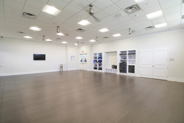 interior space featuring built in shelves and dark hardwood / wood-style floors