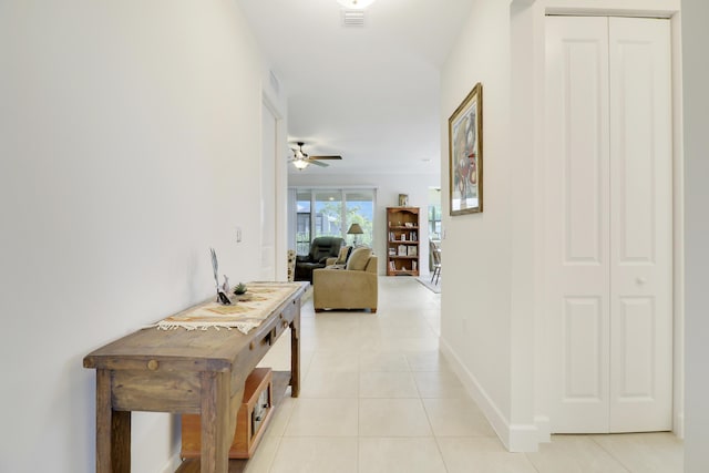 hall featuring light tile patterned floors