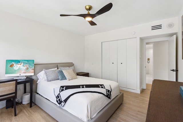 bedroom featuring a closet, ceiling fan, and light hardwood / wood-style flooring