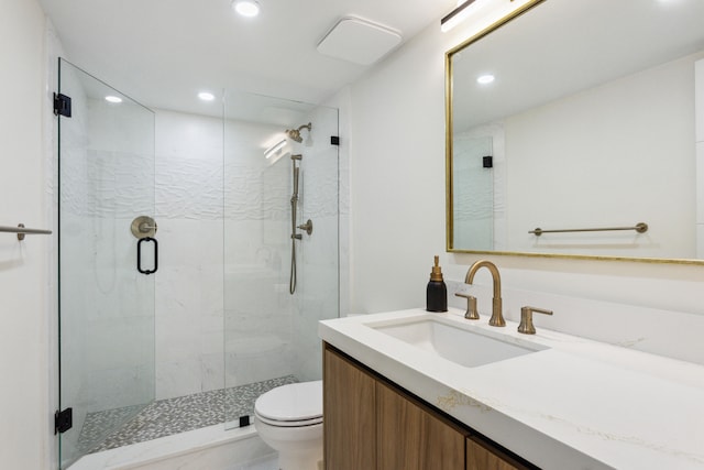 bathroom with vanity, toilet, and walk in shower