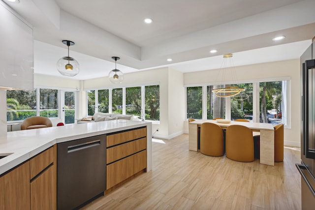 kitchen featuring stainless steel dishwasher, pendant lighting, light wood-type flooring, and an inviting chandelier