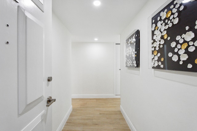 corridor with light hardwood / wood-style flooring