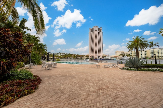 surrounding community featuring a patio and a pool