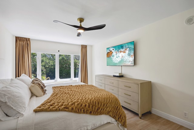 bedroom with ceiling fan and light hardwood / wood-style flooring