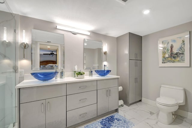 bathroom featuring vanity, toilet, and ceiling fan