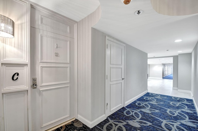 hallway featuring recessed lighting and baseboards