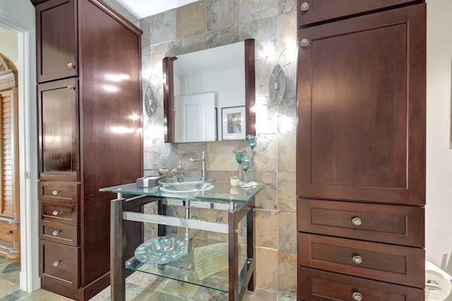 bathroom featuring tile walls and sink