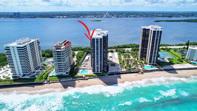 birds eye view of property with a view of the beach and a water view