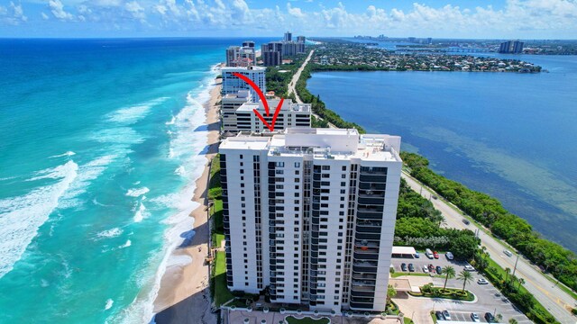 birds eye view of property with a water view and a view of the beach