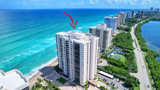 birds eye view of property with a view of the beach and a water view