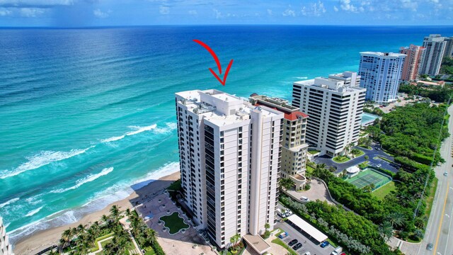 aerial view featuring a water view and a beach view