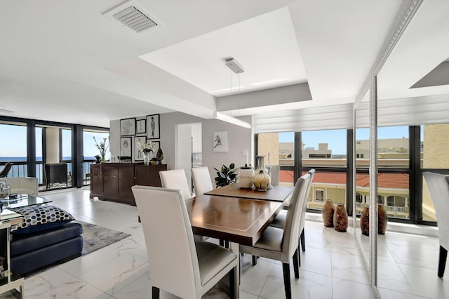 dining space with a wall of windows